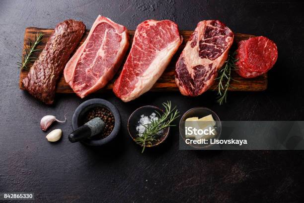 Variety Of Raw Black Angus Prime Meat Steaks And Seasoning Stock Photo - Download Image Now