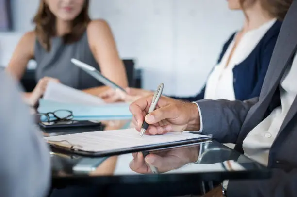 Photo of Business people writing