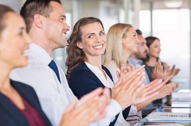 istock Happy businesspeople applauding at conference 842865866