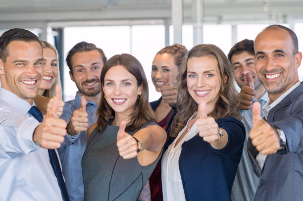 Successful business team Group of happy business people showing sign of success. Successful business team showing thumbs up sign and looking at camera. Smiling businessmen and businesswomen cheering at office. thumb photos stock pictures, royalty-free photos & images