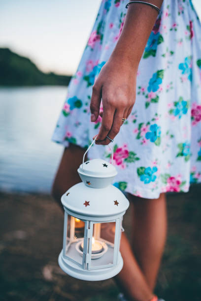 istock girl holding in hand a lantern light 842868620