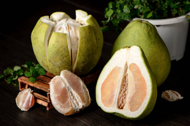 istock fresh grapefruit ,peeled grapefruit and grapefruit with slices on wooden table isolated on black background 842869806