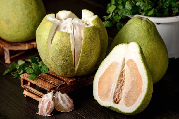 istock fresh grapefruit ,peeled grapefruit and grapefruit with slices on wooden table isolated on black background 842869830
