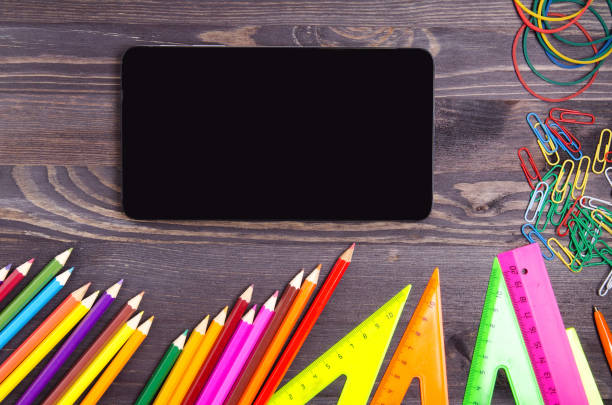 istock School supplies (pencil, pen, ruler, triangle) on blackboard background ready for your design . 842873870