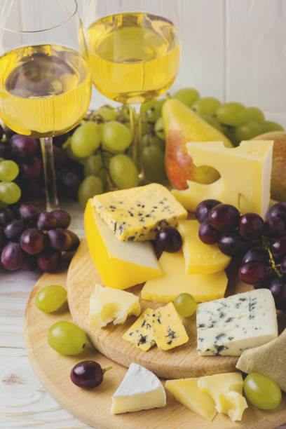 istock Cheese plate served with wine, fresh grapes and pears 842874838