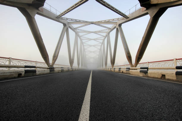 istock bridge in fog at sunrise 842878322