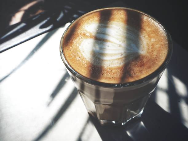Latte art coffee with shadow leaves
