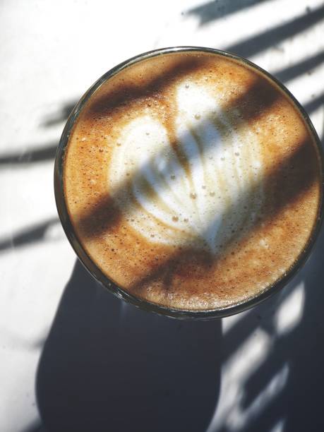 Latte art coffee with shadow leaves