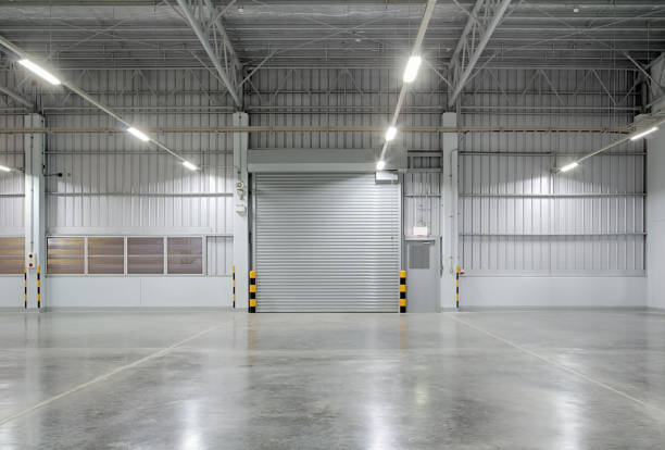shutter door factory Roller shutter door and concrete floor outside factory building for industry background. industrial building stock pictures, royalty-free photos & images