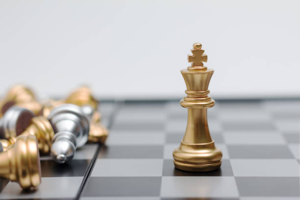 istock Gold Chess on chess board game for business metaphor leadership concept select focus on king chess shallow depth of field 842890220