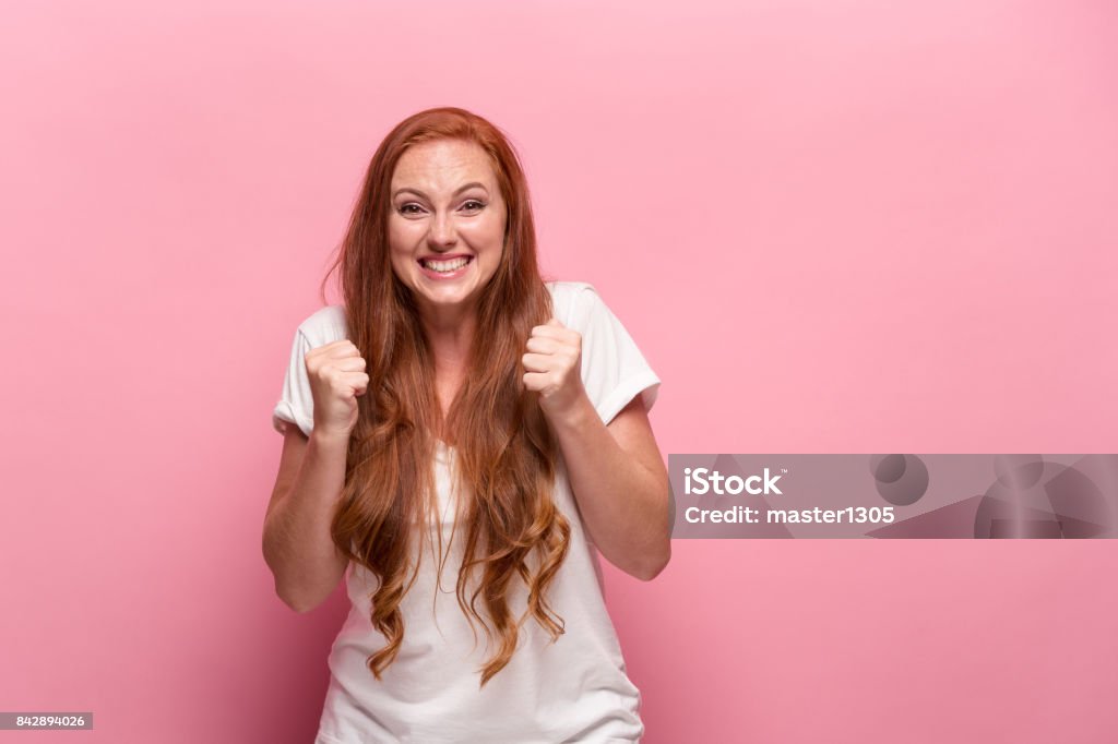 Portrait of young woman with happy facial expression Portrait of young woman with happy facial expression at studio Ecstatic Stock Photo