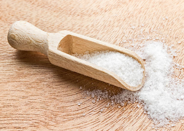 istock Sea salt in a wooden scoop. 842899516