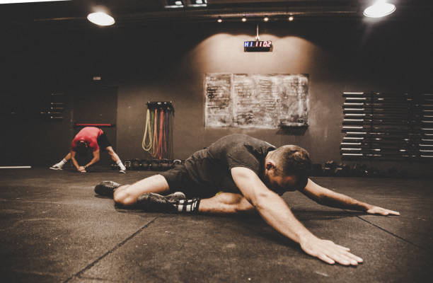 Full length shot of young male athlete lying on floor and relaxing after hard training