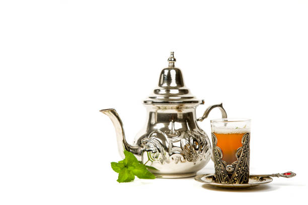 True Moroccan mint tea in the original cup True Moroccan mint tea in the original cup and teapot on the white background moroccan culture photos stock pictures, royalty-free photos & images