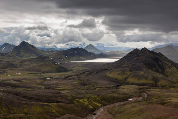 istock Dramatic Iceland scenery with green mountains covered with thick icelandic moss, heavy gray clouds and big lake. 842911404