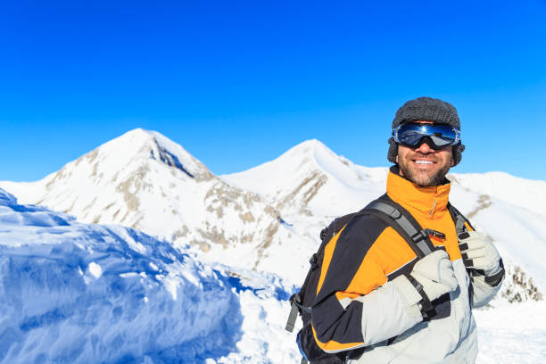 istock Male backpacker hiking in snow mountain 842914686
