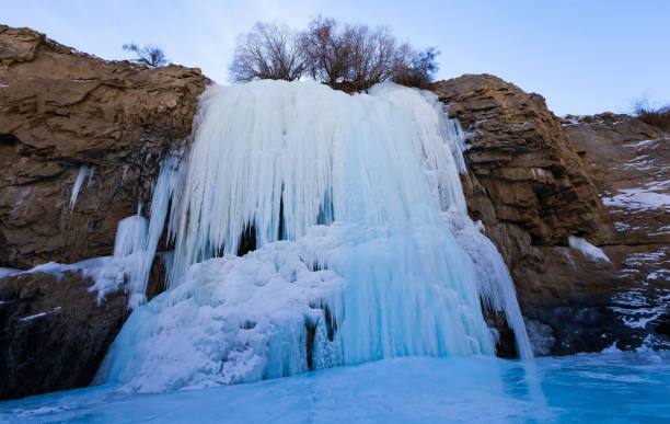 Frozen waterfall on the way of Chadar trek (The frozen Zanskar river trekking) during winter in Leh,Ladakh,India. Frozen waterfall on the way of Chadar trek (The frozen Zanskar river trekking) during winter in Leh,Ladakh,India. brightly lit winter season rock stock pictures, royalty-free photos & images