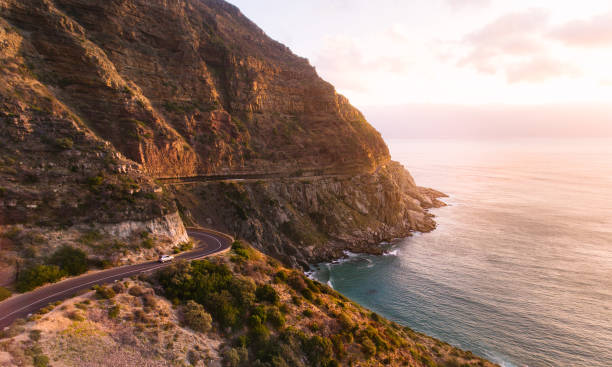Roadtrip in beautiful scenery Roadtrip in beautiful landscape. Car driving on the famous Chapmans Peak Drive stretch close to Cape Town, South Africa. chapmans peak drive stock pictures, royalty-free photos & images