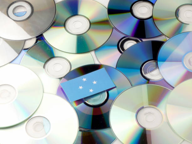 istock Micronesian flag on top of CD and DVD pile isolated on white 842915682