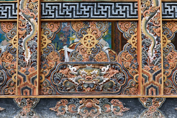 Beautiful traditional Bhutanese building is constructed with multi-colored wood frontages and involving with religious symbol such as Dhamma-wheel.