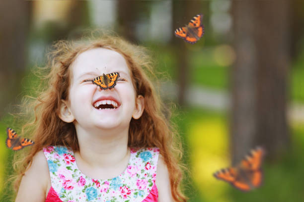 istock Surprised curly girl with a butterfly on his nose. 842920810