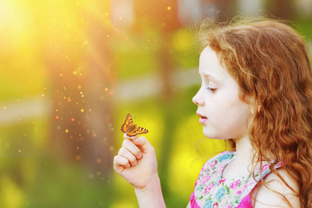istock Surprised curly girl with a butterfly on his finger. 842921106