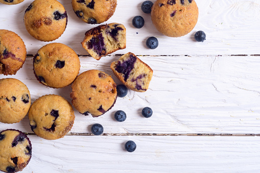 Banana muffins with blueberry on rustic background . Top view , copy space