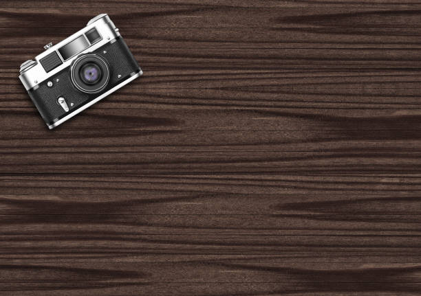 Old vintage camera on dark wooden background