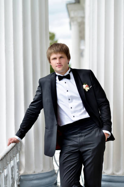 istock Handsome groom in suit in the nature 842933824
