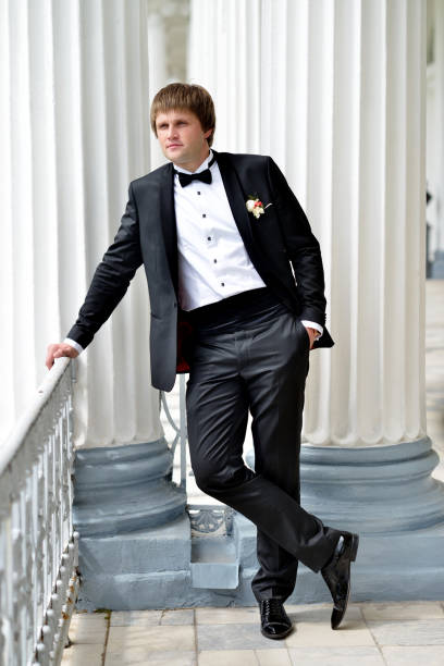 istock Handsome groom in suit in the nature 842933992