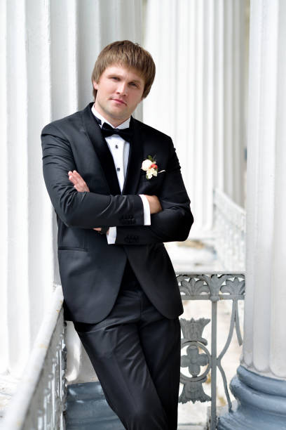 istock Handsome groom in suit in the nature 842936100