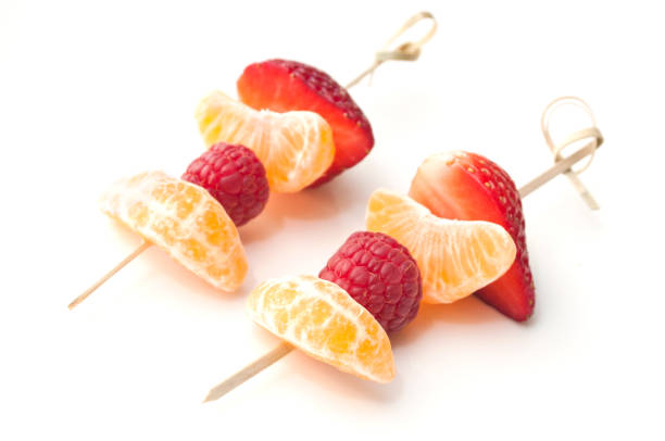 istock duo of fruits skewer presentation on white background 842940968