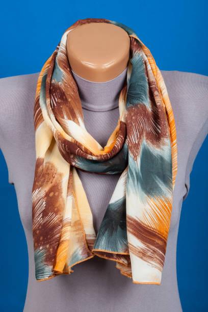 istock Beige scarf on mannequin isolated on blue background. 842941118