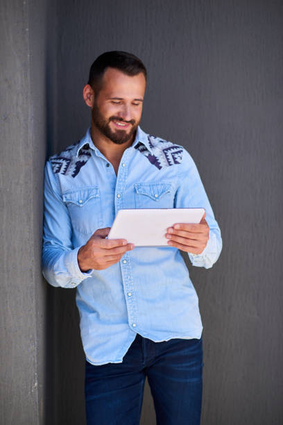istock Young businessman in casual clothes over grey wall background 842944722