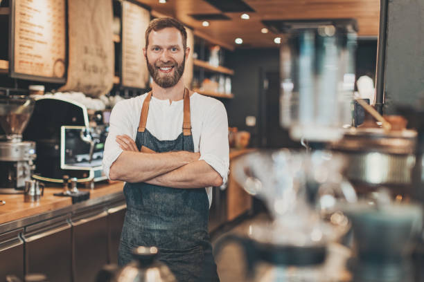 istock Smiling coffee shop owner at the bar counter 842948568