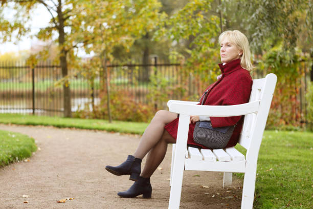 istock Senior woman in autumn park 842949624