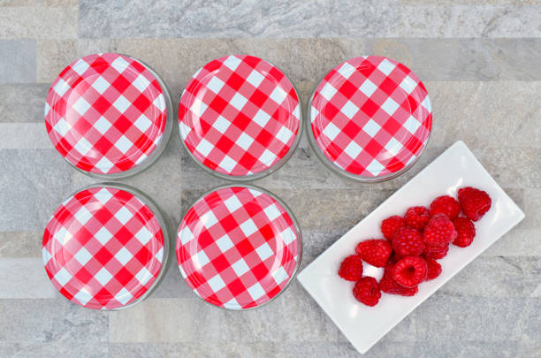 glass jars with raspberry stock photo