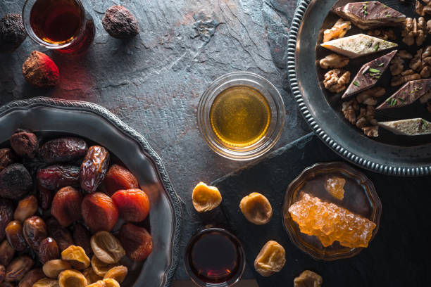istock Dried fruits, nuts on a plate and tea on a gray slate free space 842953706