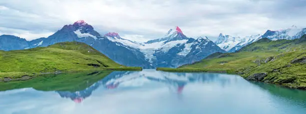 Nice landscape at sunrise over the lake in the Swiss Alps, Europe. Wetterhorn, Schreckhorn, Finsteraarhorn et Bachsee. ( relaxation, harmony, anti-stress - concept).