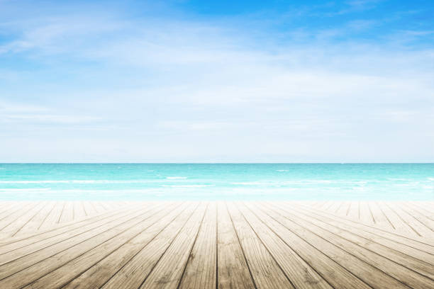 istock Empty wooden table with party on beach background blurred. 842971890