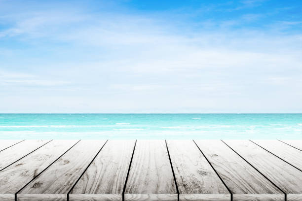 istock Empty wooden table with party on beach background blurred. 842971940
