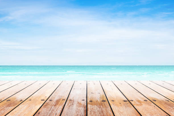 istock Empty wooden table with party on beach background blurred. 842972098