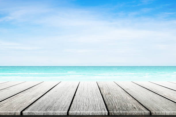 istock Empty wooden table with party on beach background blurred. 842972148