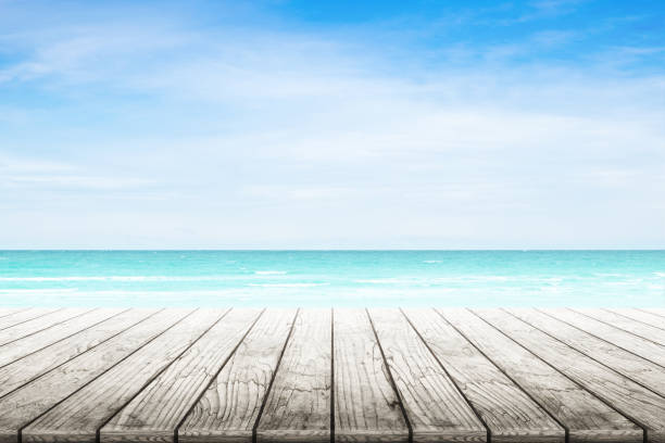 istock Empty wooden table with party on beach background blurred. 842972196