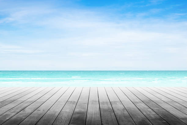 istock Empty wooden table with party on beach background blurred. 842972318