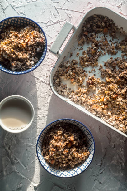 istock Form for baking, bowls with granola and coconut milk on a white table 842976866