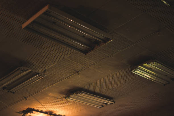 Old dusty storage (warehouse). Ceiling with old-fashioned abandoned neon lamps.