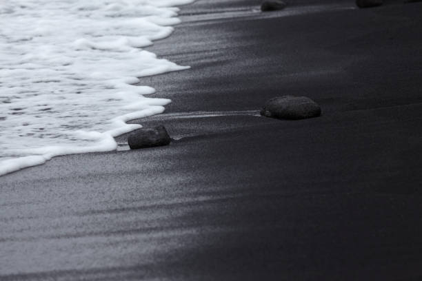 Black Sand Beach with white wave at Punalu'u, Hawaii stock photo