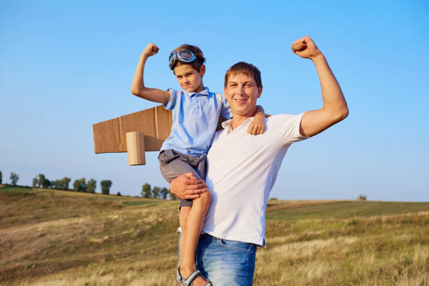 istock Father and son show muscles in nature. 842988938