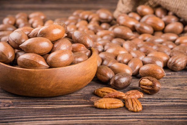 Pecan nuts Pecan nuts on wooden background duchess photos stock pictures, royalty-free photos & images